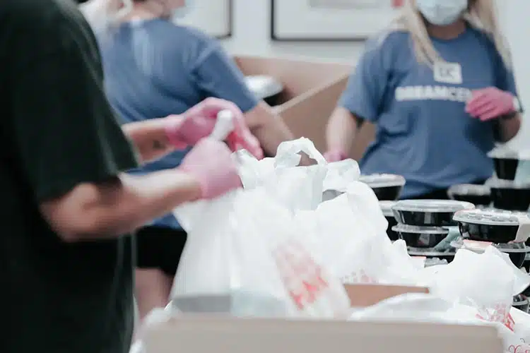 Engaging Video by Vermillion Films. A photo of people filling bags at a food bank in Birmingham