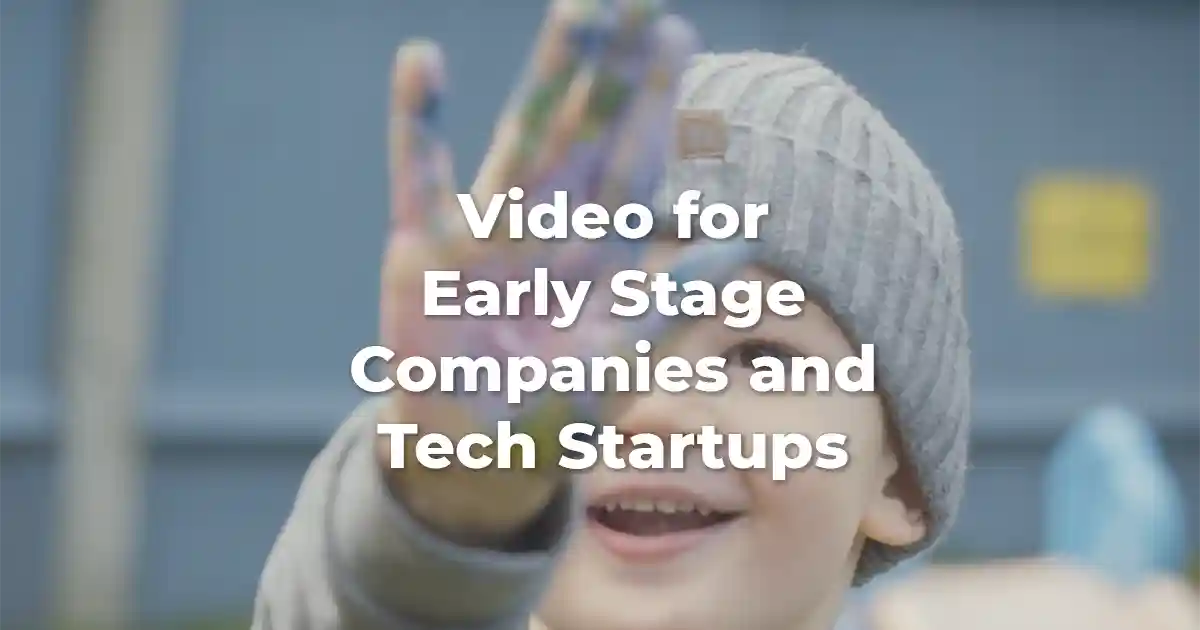A small child holding up paint on his hand. There is text across the middle that says "video for early stage companies and tech startups" Early Stage Video production by Vermillion Films in Birmingham and London